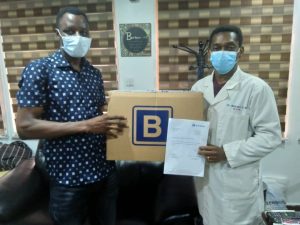 Medical Director of Lagos Island Maternity, Dr. Olufemi Omololu, right receiving a carton of Personal Protective Equipments from representative of Julius Berger Nigeria Plc, Mr Johnpaul Iyelolu Thursday in Lagos