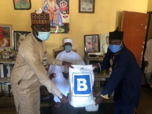 L-R; Ibrahim Yusuf of Julius Berger AKR Project presents food palliatives to the District head at Zaria in Kaduna State, recently